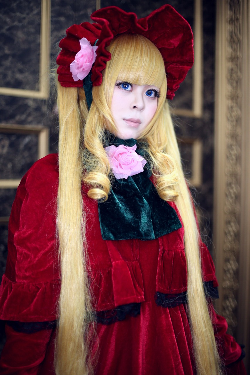 1girl bangs blonde_hair blue_eyes blurry bonnet bow dress drill_hair flower lips long_hair looking_at_viewer photo red_dress rose shinku solo twintails