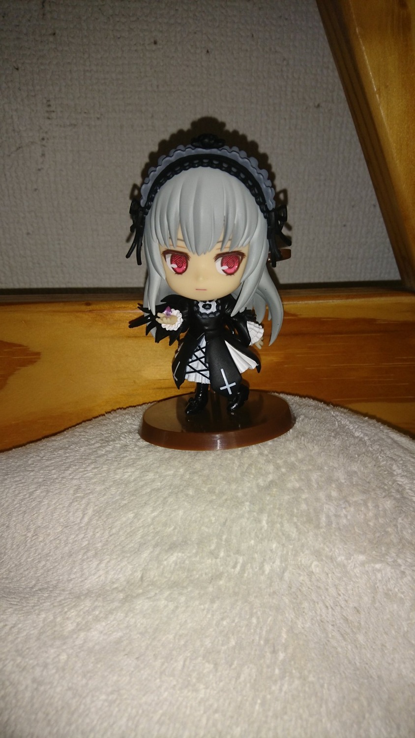 1girl black_dress chibi doll dress flower frills gothic_lolita hairband lolita_fashion long_hair looking_at_viewer photo red_eyes rose silver_hair sitting solo suigintou wings