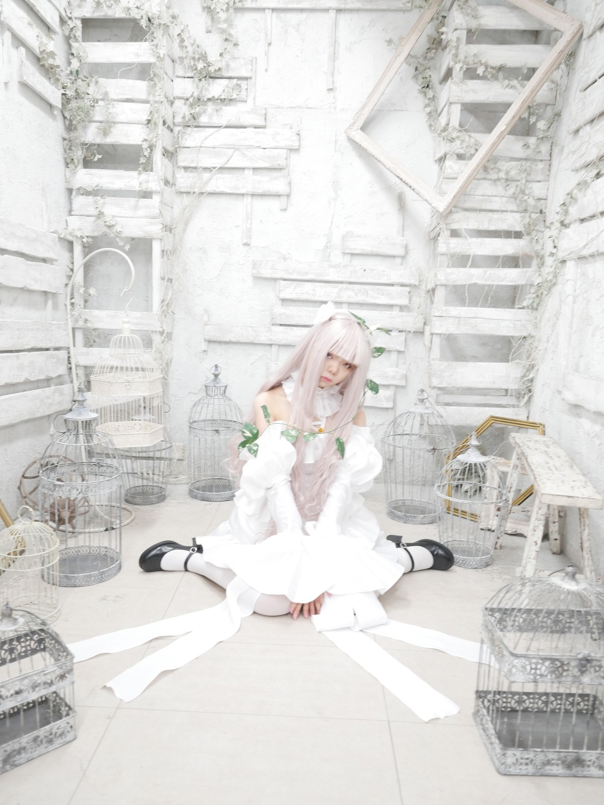 1girl bare_shoulders city dress kirakishou long_hair shoes sitting solo white_hair white_legwear white_theme