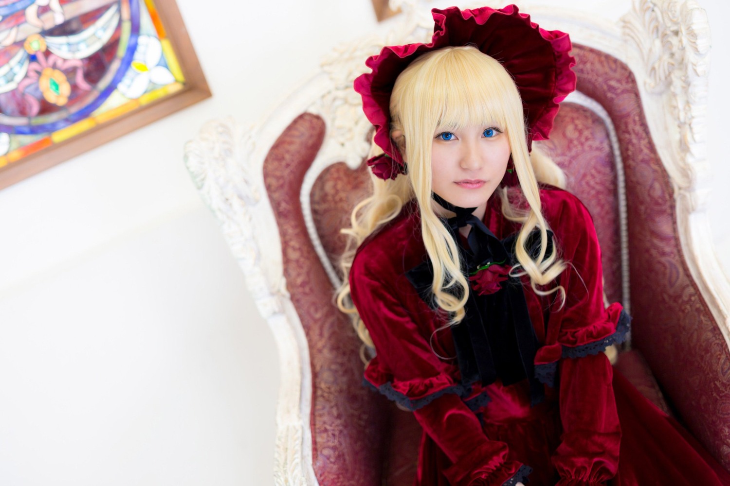 1girl blonde_hair blue_eyes blurry blurry_background bonnet depth_of_field dress flower long_hair long_sleeves looking_at_viewer photo red_dress rose shinku solo