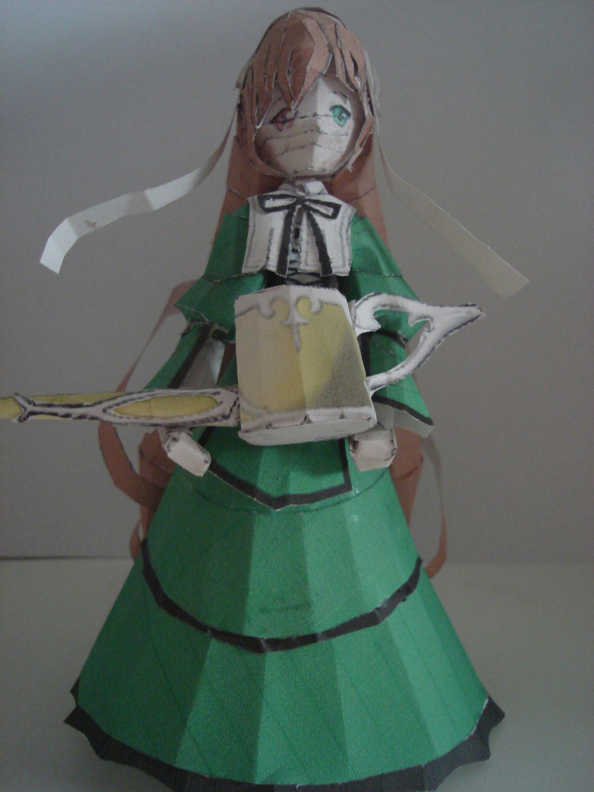 1girl bangs brown_hair doll dress green_dress grey_background holding knife long_hair long_sleeves puffy_sleeves simple_background solo suiseiseki