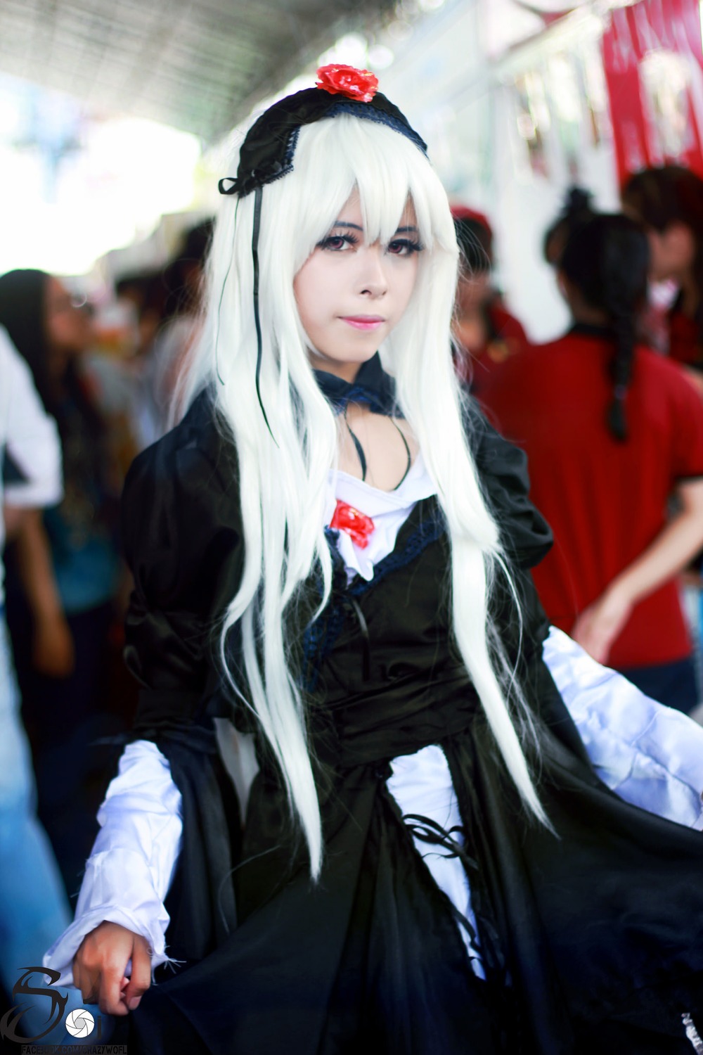 1girl auto_tagged black_dress blurry blurry_background blurry_foreground depth_of_field dress hairband long_hair long_sleeves looking_at_viewer motion_blur photo solo solo_focus suigintou white_hair