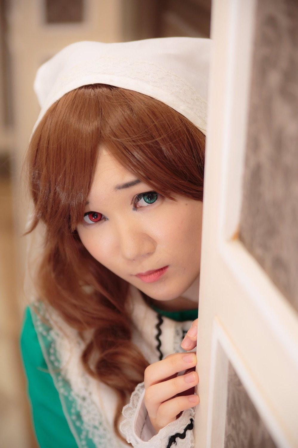 1girl blue_eyes blurry blurry_background blurry_foreground brown_hair closed_mouth depth_of_field frills heterochromia lips long_hair looking_at_viewer realistic smile solo suiseiseki