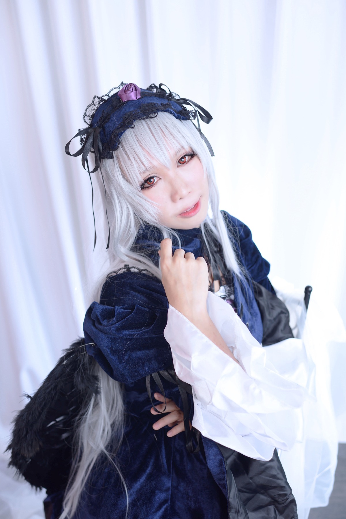 1girl gun hairband handgun holding holding_gun holding_weapon long_hair long_sleeves looking_at_viewer red_eyes silver_hair solo suigintou weapon wings