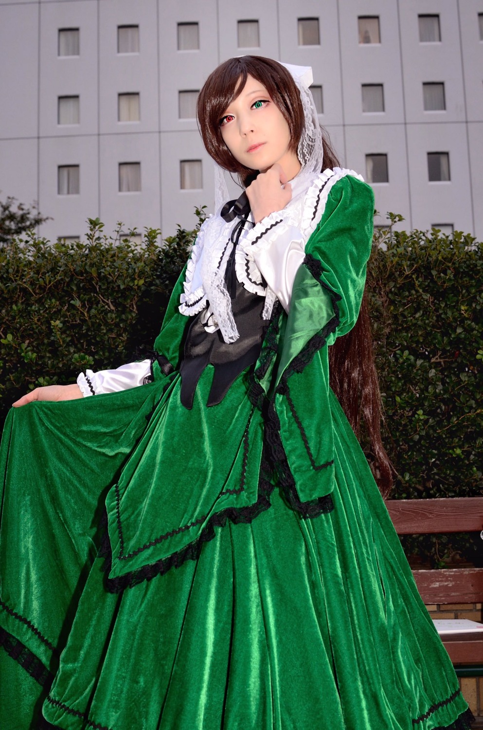 1girl brown_hair dress green_dress green_eyes heterochromia long_sleeves looking_at_viewer red_eyes short_hair solo standing suiseiseki swept_bangs