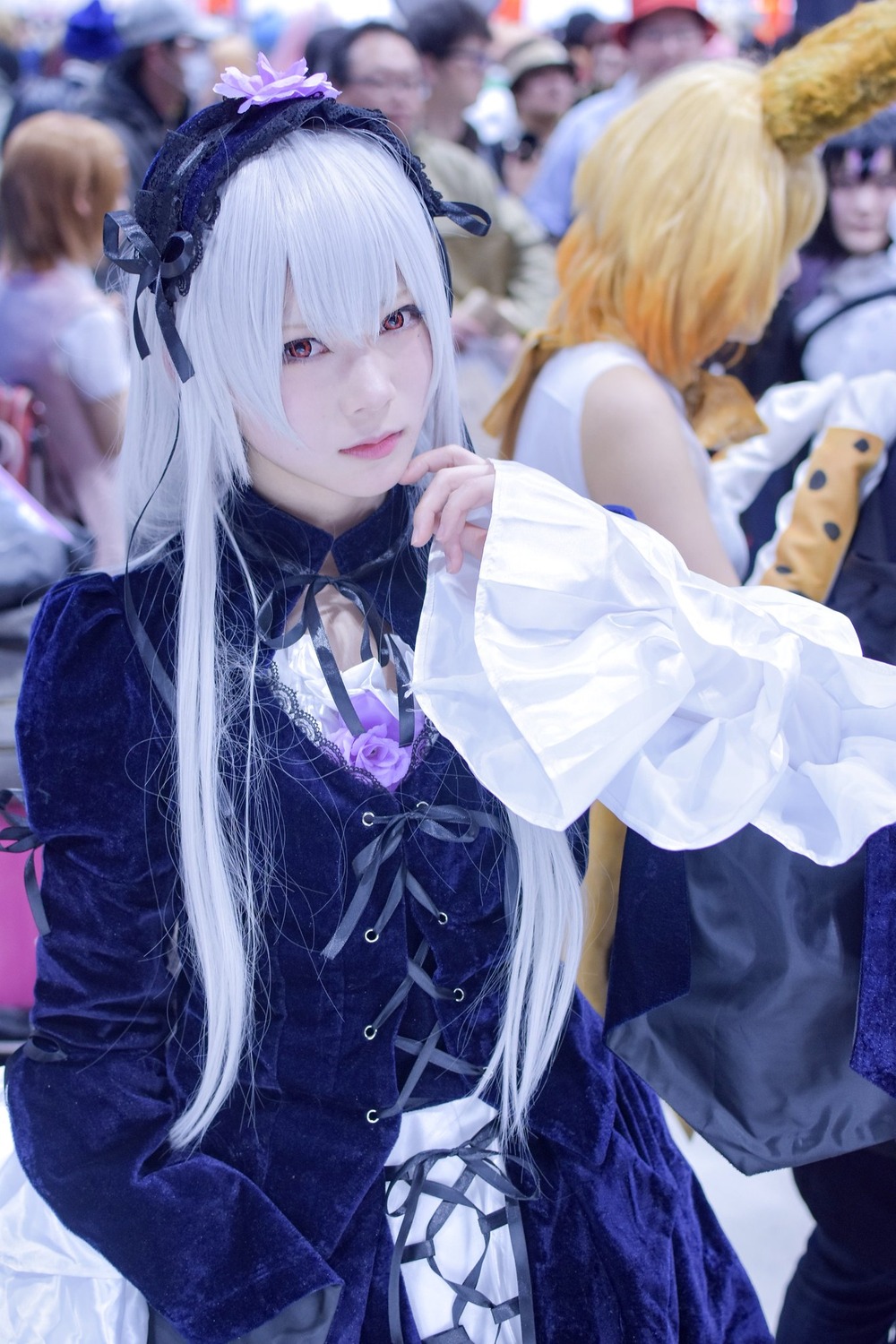 blonde_hair blurry blurry_background blurry_foreground depth_of_field dress frills hairband long_hair looking_at_viewer multiple_girls photo red_eyes ribbon solo suigintou white_hair