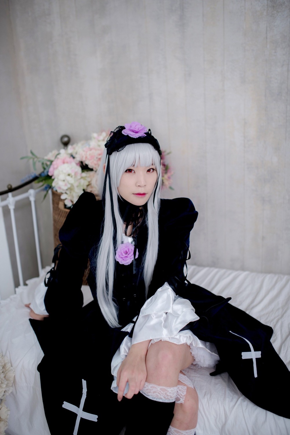 1girl bangs black_dress dress flower gothic_lolita kneehighs lips long_hair long_sleeves looking_at_viewer red_eyes sitting solo suigintou