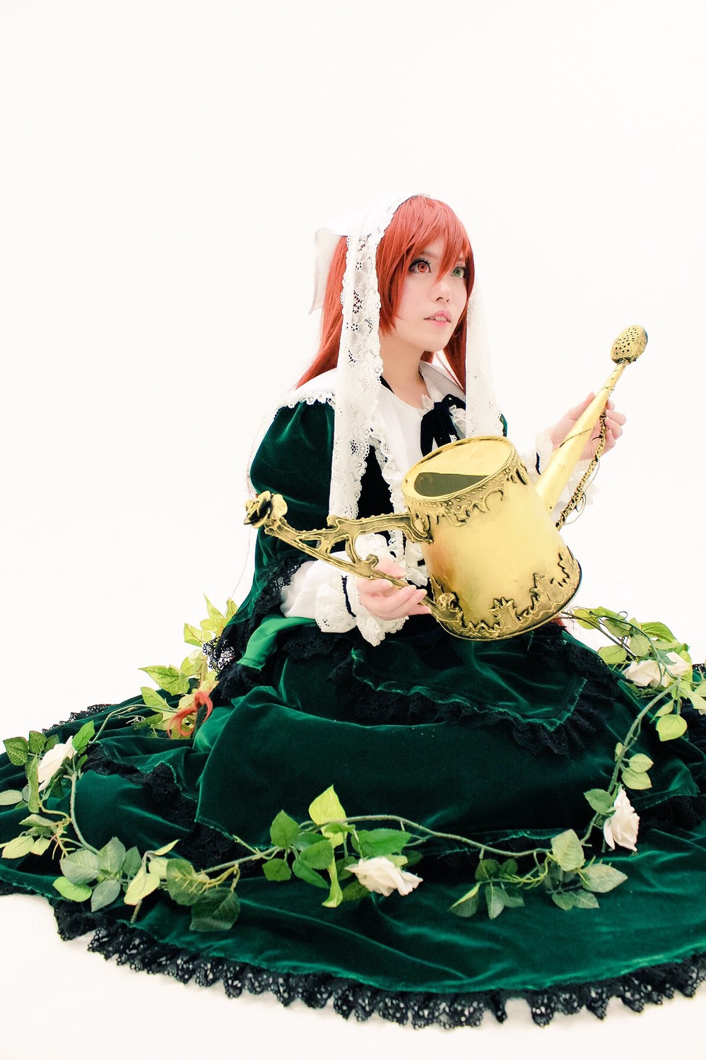 1girl black_dress dress flower green_dress long_hair long_sleeves looking_at_viewer pink_hair sitting solo suiseiseki