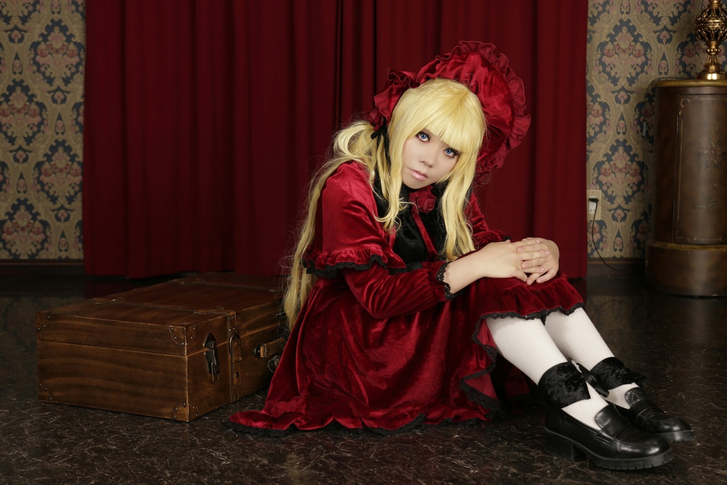 1girl blonde_hair blue_eyes bonnet capelet curtains dress flower long_hair long_sleeves looking_at_viewer red_capelet red_dress rose shinku shoes sitting solo twintails