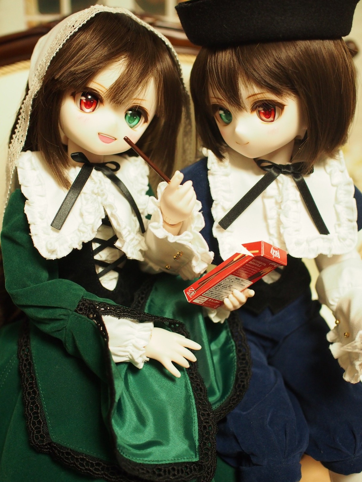 2girls brown_hair doll dress frills green_dress hat heterochromia long_sleeves looking_at_viewer multiple_dolls multiple_girls open_mouth red_eyes short_hair siblings sisters smile souseiseki suiseiseki tagme twins