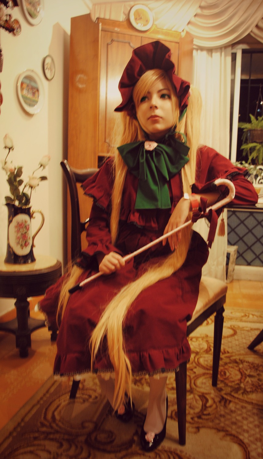 1girl auto_tagged barefoot blonde_hair blue_eyes bonnet bow chair cup curtains dress indoors long_hair painting_(object) realistic red_dress shinku sitting solo teacup